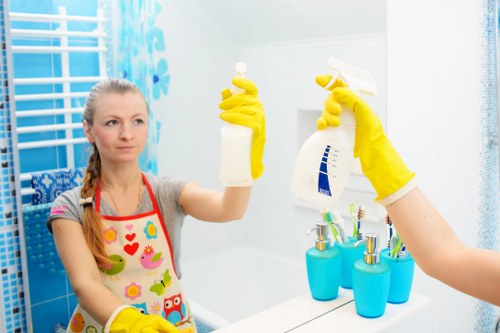 Cleaner preparing an oven cleaning area with safety precautions in place