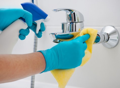 Local cleaner treating stains on a lounge sofa in Lewisham